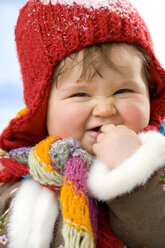 Baby girl (12-15 months) wearing cap, smiling, close-up - SMOF00030