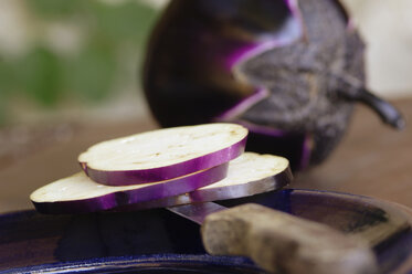 Sliced eggplant on knife and plate, close-up - ASF02647