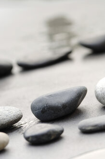 Pebbles in sand, in a row - ASF02725