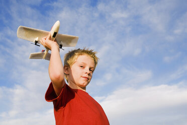 Boy (10-12) holding model aircraft - RDF00160