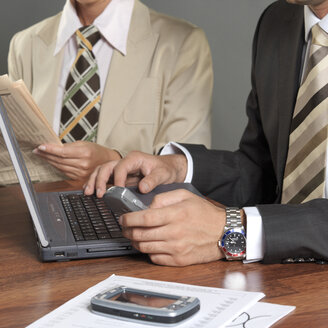 Businessman writing on laptop - JLF00267