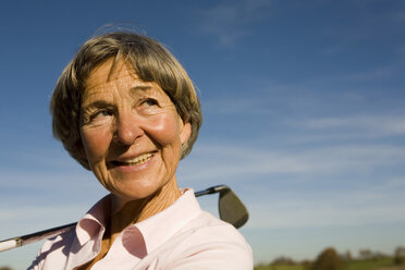 Senior adult woman holding golf club - WESTF03447