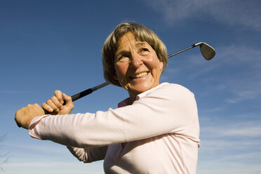 Senior adult woman holding golf club - WESTF03446