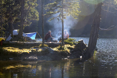 Man and woman camping on small island stock photo