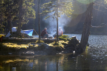 Man and woman camping on small island - HHF00934