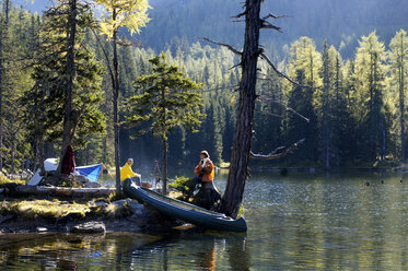 Man and woman camping by lake - HHF00933