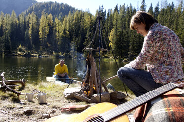 Man and woman camping at lake - HHF00921