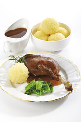 Roast goose with side dishes, elevated view - 05599CS-U