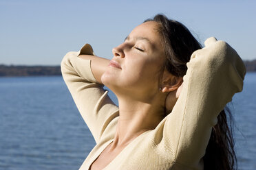 Young woman sunbathing, side view - LDF00398