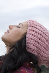 Young woman wearing cap, eyes closed, side view - LDF00384