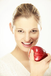 Young woman holding apple, close-up, portrait - LDF00437