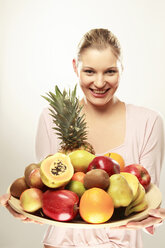 Young woman holding various fruits - LDF00434