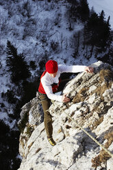 Germany, Bavaria, young woman climbing on rock - FFF00737