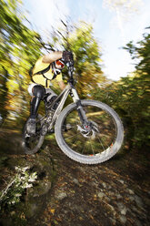 Germany, Bavaria, man performing jump on bicycle - FFF00719