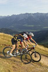 Austria, Tirol, couple riding bicycle - FFF00717