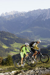 Austria, Tirol, couple riding bicycle - FFF00716