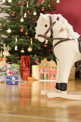 Rocking horse, detail, Christmas tree in background - WESTF04044