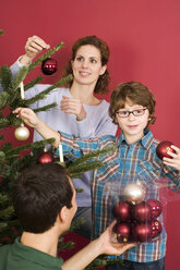 Familie beim Schmücken des Weihnachtsbaums - WESTF04006