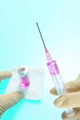 Person holding syringe, close-up - THF00427