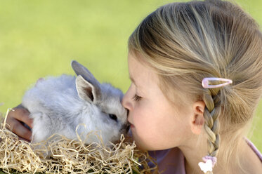 Mädchen (6-7) küsst Osterhase - CRF01089