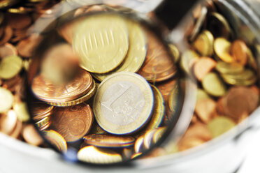 Pot of euro coins under magnifying glass, close-up - 06041CS-U