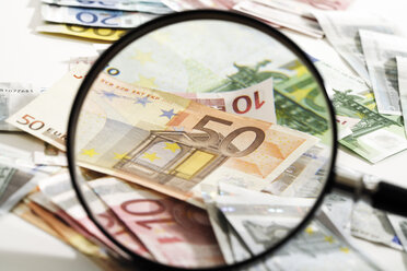 Euro banknotes under magnifying glass, close-up - 06040CS-U