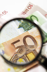 Euro banknotes under magnifying glass, close-up - 06038CS-U