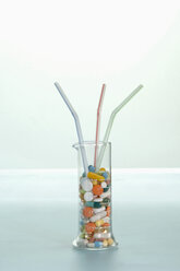 Pills in glass with straws, close-up - ASF03042