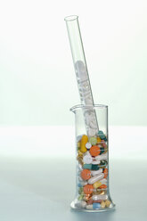 Various pills in test tube and glass, close-up - ASF03033