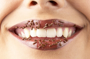 Young woman with chocolate granules on lips, detail - THF00501