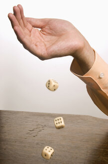 Human hand throwing dice, close-up - LDF00456