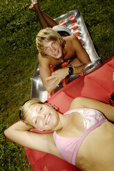 Teenage couple on air bed, portrait, elevated view - WESTF04390