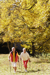 Senior couple Nordic walking outdoors, elevated view - WESTF04300