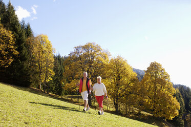 Senior couple Nordic walking outdoors - WESTF04299