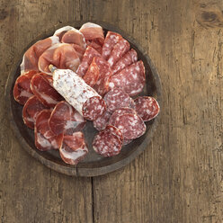Sliced salami and ham on plate, elevated view - WESTF04628