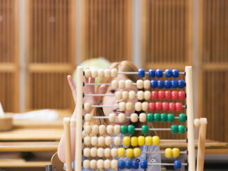 Girl (4-7) using abacus, close-up - WESTF04584