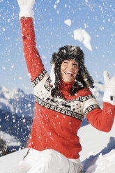 Woman in mountains, throwing snow - HHF01355