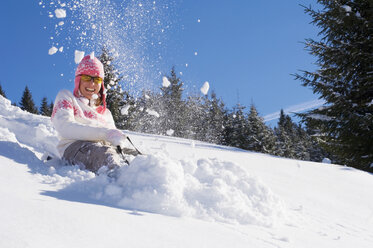 Woman tobogganing in mountains - HHF01301