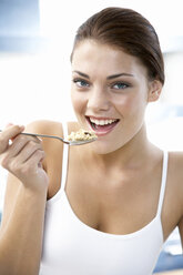 Young woman eating muesli - WESTF05047