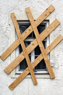 Window nailed up with wooden boards - 00251LR-U