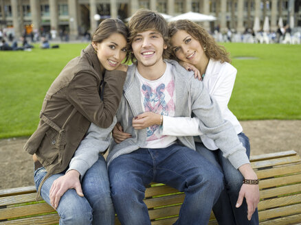 Germany, Stuttgart, young people sitting on bench - KMF00965