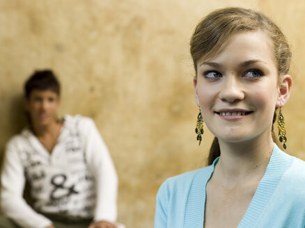 Young woman, portrait, young man leaning in background - KMF00872