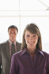 Two businesspeople, man and woman smiling - WESTF05501