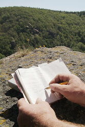 Man writing notes in notebook - PKF00072