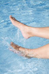 Woman`s feet in swimming pool, close-up - LDF00496