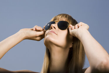 Young woman wearing sunglasses, portrait - CLF00415