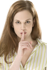 Young woman holding finger to lips, portrait, close-up - CLF00402