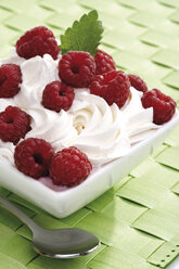 Rasberries on whipped cream in bowl, close-up - 06884CS-U