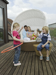 Family on balcony, children playing - WESTF05954