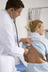 Doctor auscultating female patient - WESTF05637